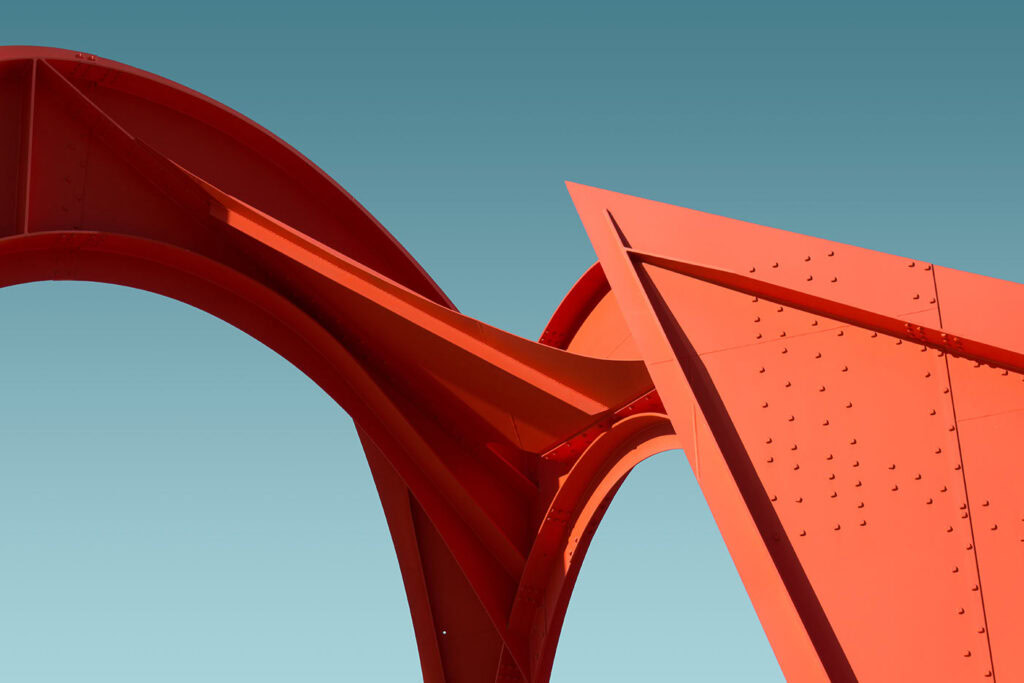 Red architectural sculpture with smooth curves and angular design elements.