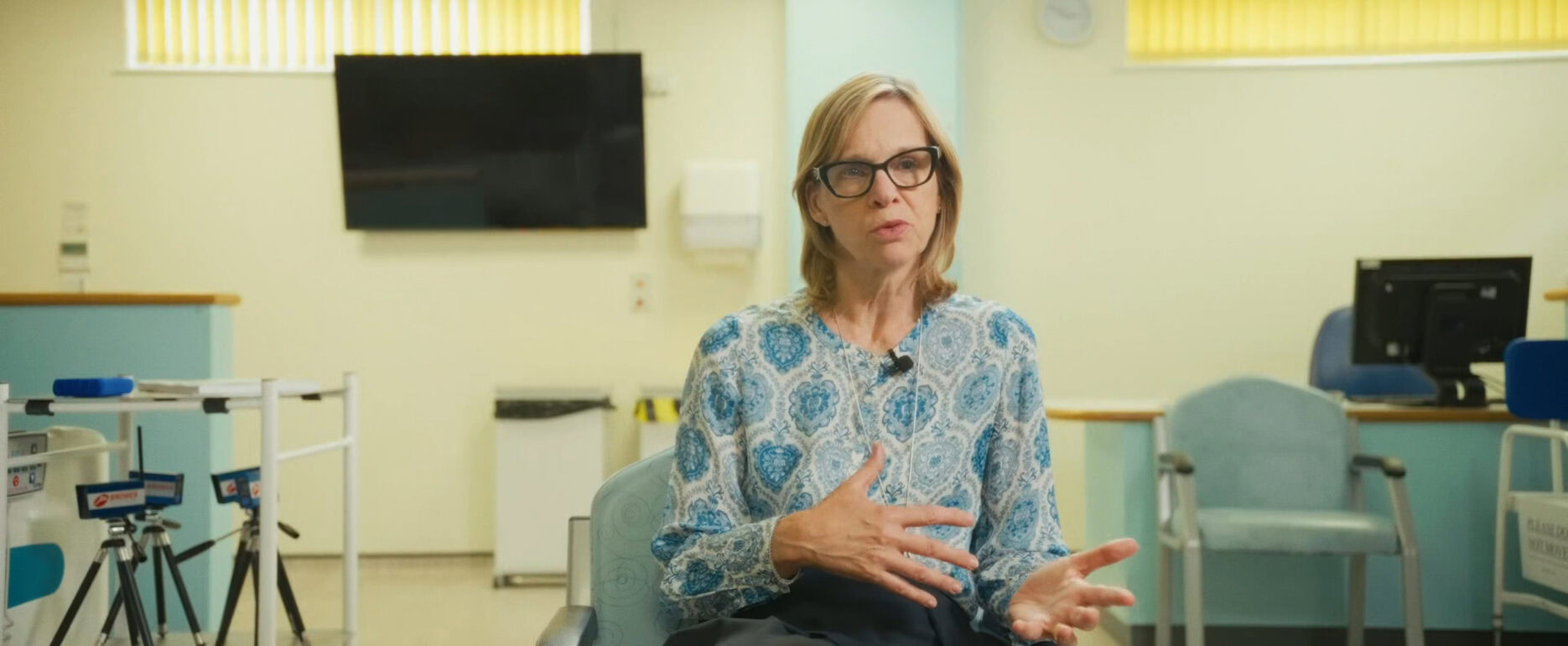 Woman doctor consulting patient in NHS hospital setting.